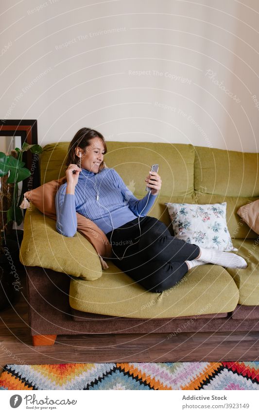 Relaxing woman with smartphone on office couch rest business texting using device sofa connection browsing surfing relax internet gadget mobile modern
