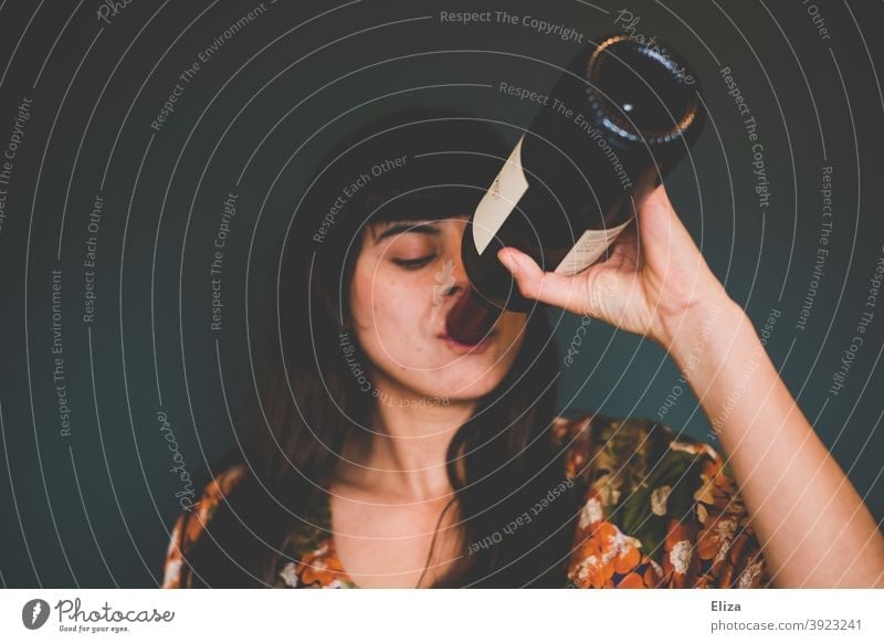 Young woman drinking red wine from bottle Vine Drinking Bottle Red wine Alcoholic drinks alcohol consumption get drunk drink wine from the bottle