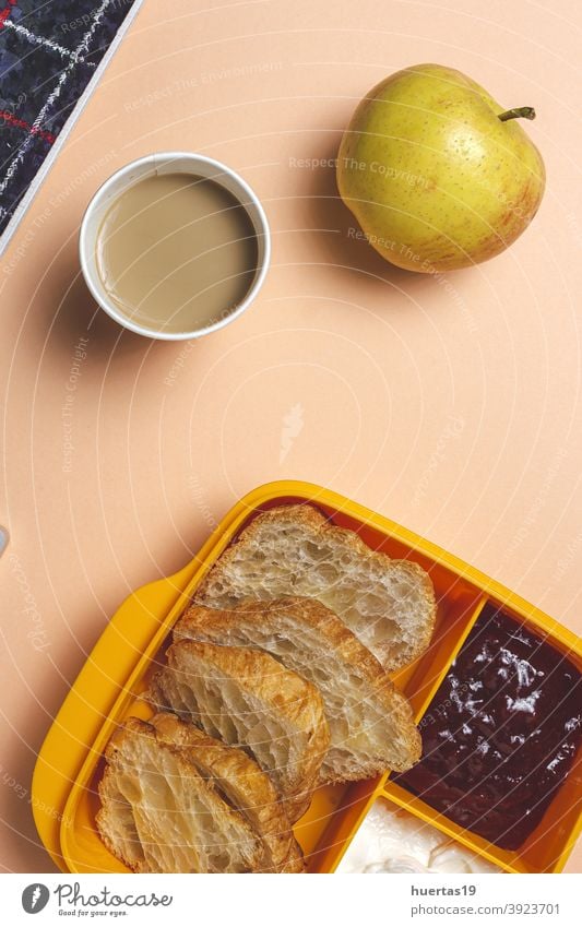 breakfast at workplace on work table from above food croissants apple coffee jam butter take way office food container business delivery take away food
