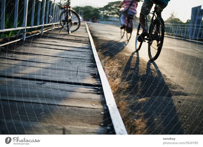 people crossing the bridge with bicycle outdoor person cyclist lifestyle cycling man recreation sport transportation adult bike road adventure summer horizontal
