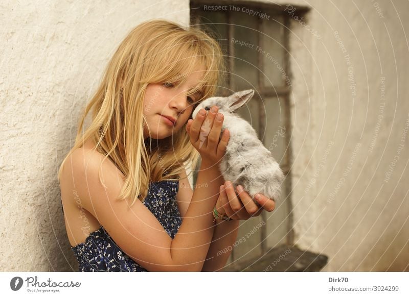 Young girl with rabbit young girl Girl Girlish romantic affectionately Love of animals Animal lover animal friendship Delicate tenderness Small Cute cautious
