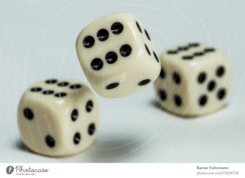 Dice are thrown on a table cubes games Crap game Happy unlucky Throw dice Game of chance Playing Compulsive gambling Colour photo Leisure and hobbies