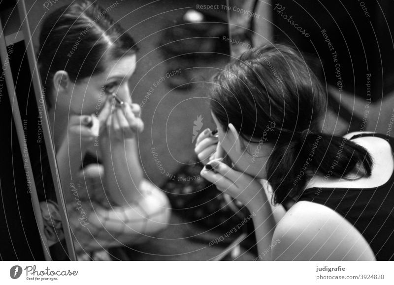 Girl puts on make up in front of mirror Woman Black & white photo Young woman Hair and hairstyles Human being make-up Apply make-up Feminine