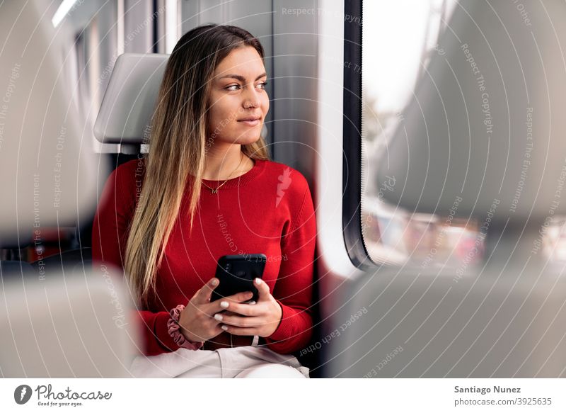 Young Blonde Girl in Train train traveling girl portrait young 20s front view blonde pretty phone using phone cellphone caucasian looking standing woman female