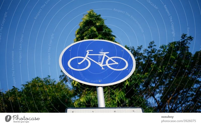 close up of bicycle sign Bicycle Sign Transport Road sign Street Signs and labeling Street sign Day Traffic infrastructure Colour photo Town Safety Blue Tree