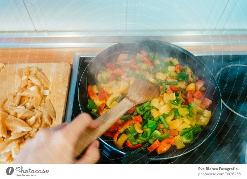 unrecognizable woman preparing vegetables food in pan. Healthy food kitchen pepper colorful healthy stir low carrot cabbage cut spoon vegan red sauteed broccoli