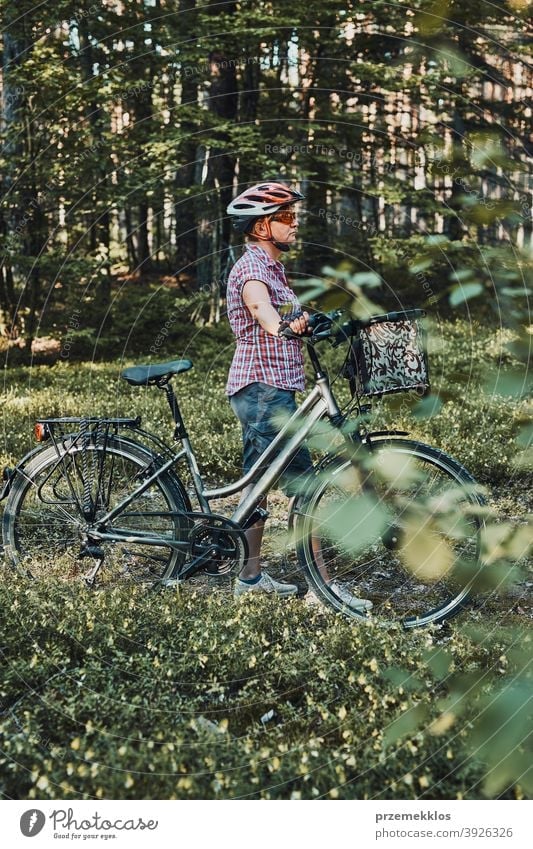 Active woman spending free summer vacation time on a bicycle trip in a forest joy freedom fall recreation adventure enjoy forest landscape forest trees