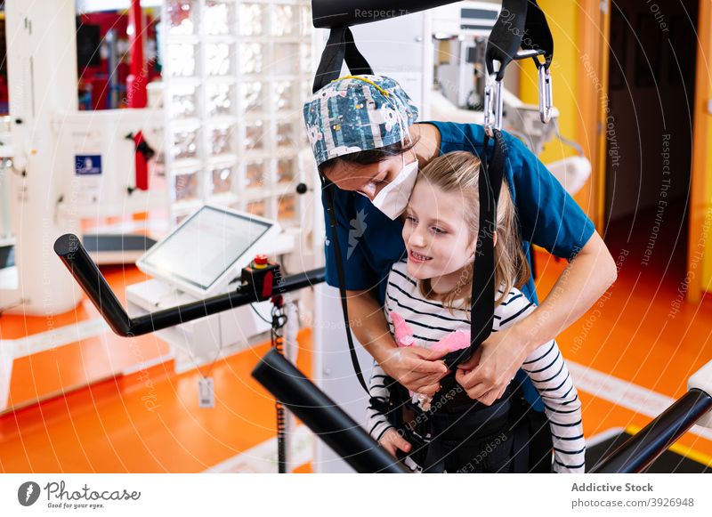 Disabled girl preparing for physiotherapy exercise rehabilitation disable kid equipment prepare training development activity child syndrome angelman disorder