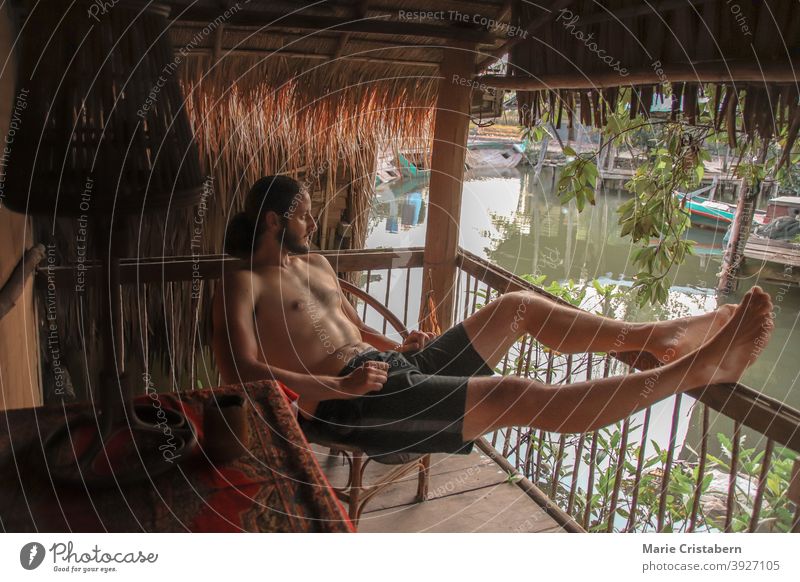 Person relaxing on the balcony during a lazy summer afternoon peaceful free time casual resting life relaxation concept legs carefree freedom peace of mind