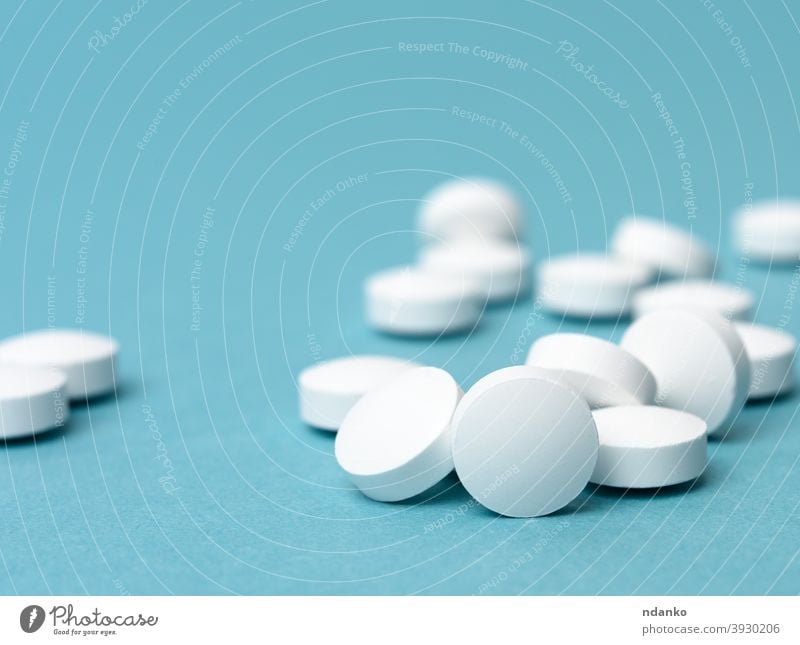 White round pill for health care. Medical treatment, blue background Vitamin Pill Prescription remedy Round science Set Illness aspirin Blue Chemicals Chemistry