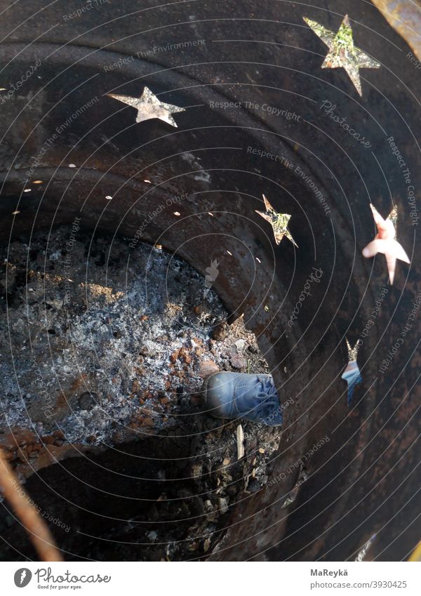 Starry sky in the fire barrel with child's foot stars ash Fire Childrens shoe Feet Rust rusty