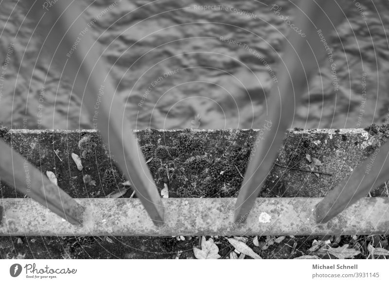 Railing and wall on a river Water River Flow Deserted Black & white photo Exterior shot rail Protection Movement Downward