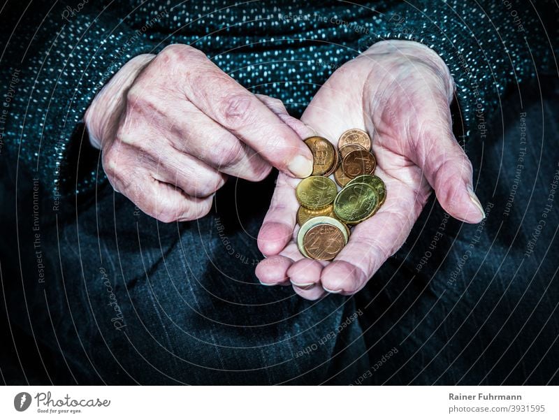 an elderly woman holds in her hands few coins Old wrinkled Woman Pensioners annuity Poverty Coins Money Hard cash Save Thriftiness Investment Loose change Euro