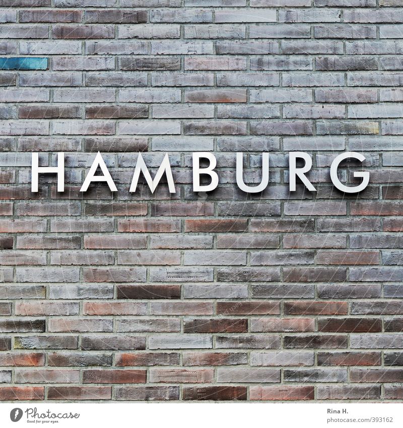 HAMBURG Wall (barrier) Wall (building) Facade Stone Metal Characters Identity Hamburg Brick Typography Colour photo Deserted Copy Space top Copy Space bottom