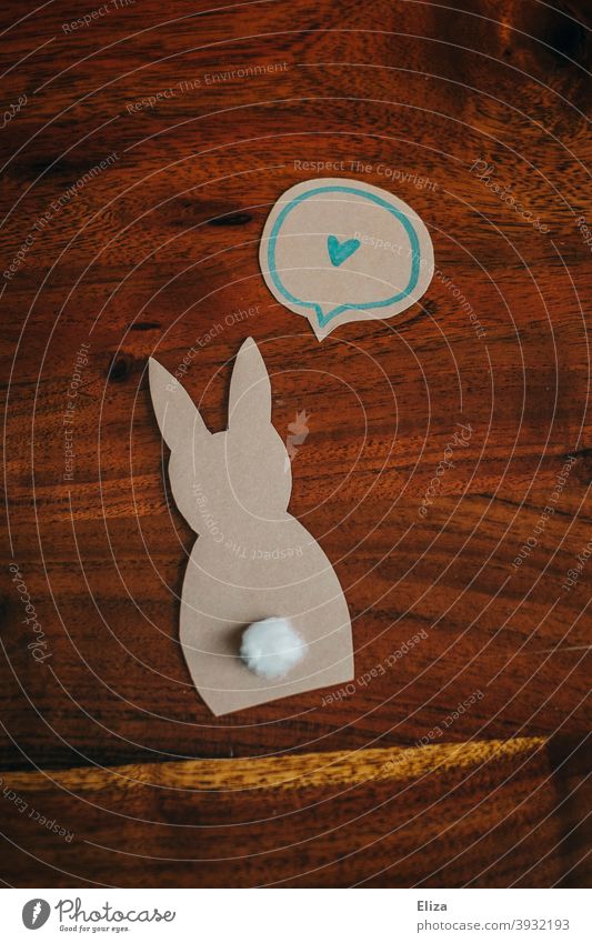 Paper Easter bunny with speech bubble and heart. Easter decoration. rabbit Brown background Handicraft Silhouette silhouette Easter Bunny Animal Hare ears Heart