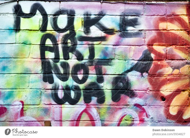 "Make Art Not War" quotation written in black paint Colour photo Exterior shot Copy Space left Central perspective Urban Graffiti Brick wall Street art
