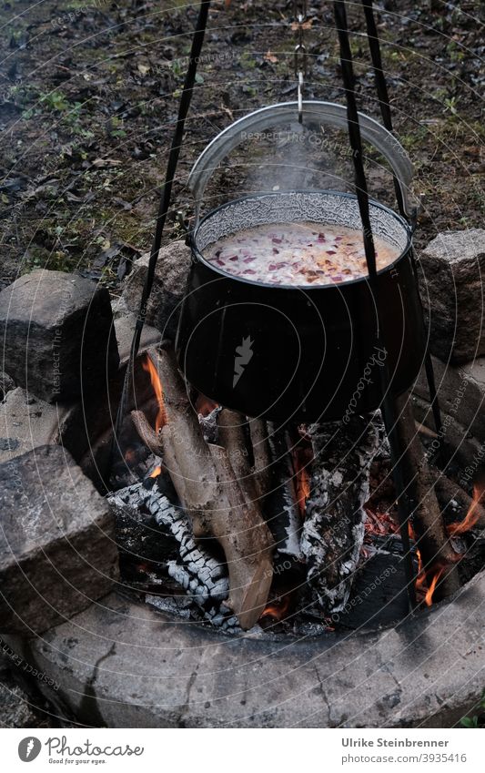 Hungarian fish soup over campfire boil Boiler Tripod Fire Fireplace Soup christmas dinner Embers Warmth Hot Flame Burn steam Soup kettle witch's cauldron