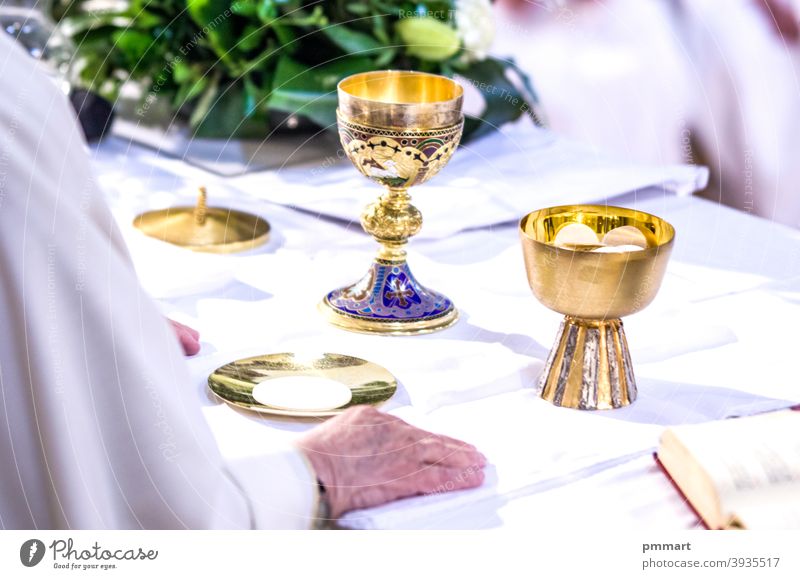 hands of Pope Francis with host and chalice with wine in the churches of the world papa altar missal book cup cross christianity gold sacred pyx goblet hosts