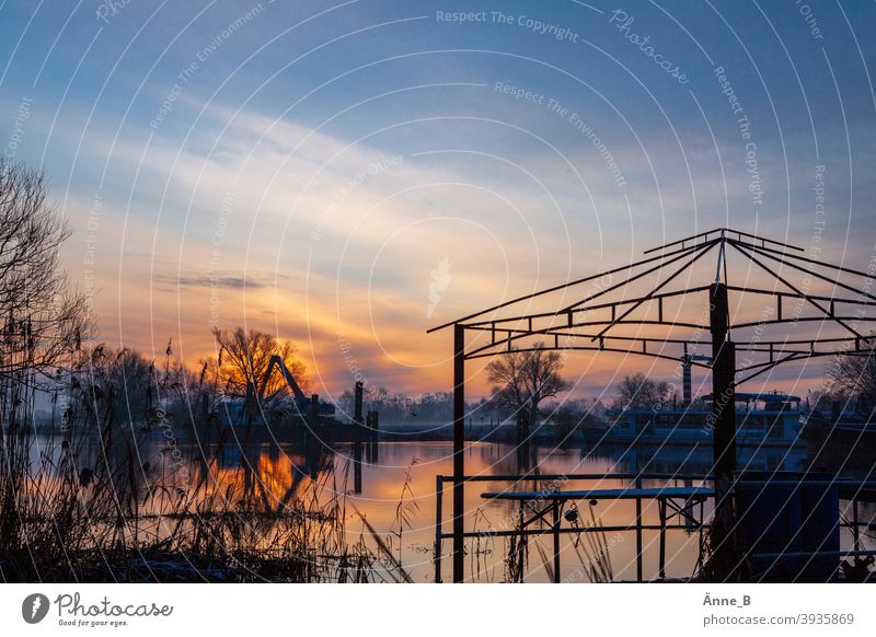 Sunrise at the river Water River Havel trees Structure Rafts Roof Scaffolding Pavilion Roof scaffolding reflection Clouds Sky Silhouette Blue Red Orange Light