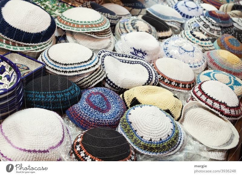 A sales table with different religious headgear for Jews (Kippa) Tradition Holy Church Spirituality Sign Symbols and metaphors Christianity religion