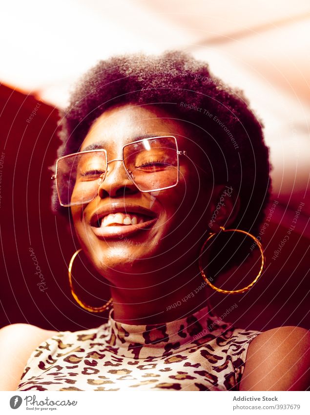 Joyful African American woman in trendy sunglasses style cheerful joy afro modern young laugh female african american black hipster ethnic optimist eyewear