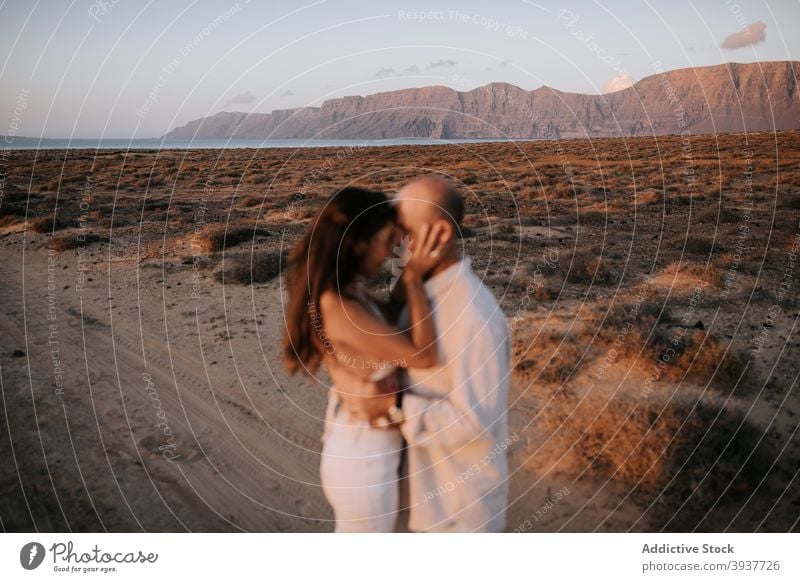 Couple standing back to back in nature couple love peaceful savanna evening twilight white outfit touch together boyfriend relationship tender calm girlfriend