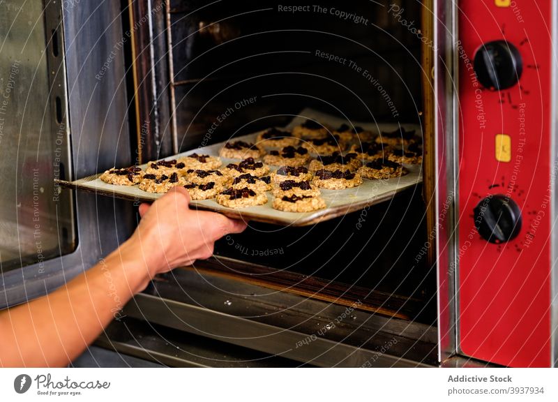 Chef baking cookies in oven pastry confectionery bake chef prepare kitchen professional dough sheet tray culinary food cuisine work sweet process job industrial