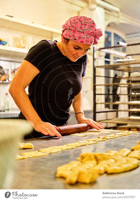 Chef preparing pastry in professional kitchen dough roll rolling pin chef prepare culinary woman cook food cuisine work process job occupation gastronomy female