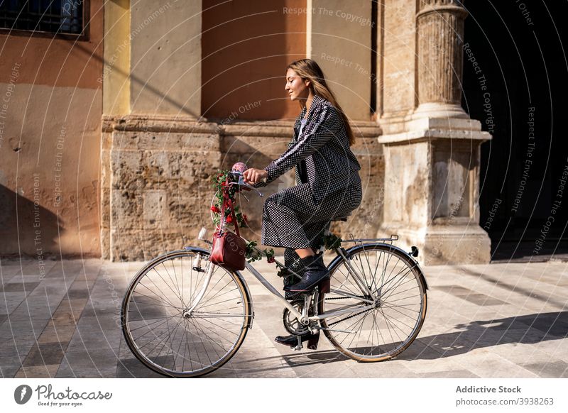 Happy woman riding bicycle on city street ride urban style having fun happy bike enjoy young female lifestyle trendy optimist positive excited activity modern