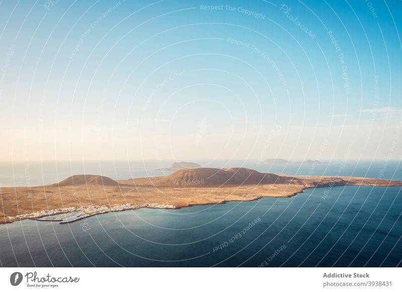 Picturesque seascape with volcanic island against cloudless sunset sky nature coast volcano crater shore picturesque scenic idyllic graciosa lanzarote canary