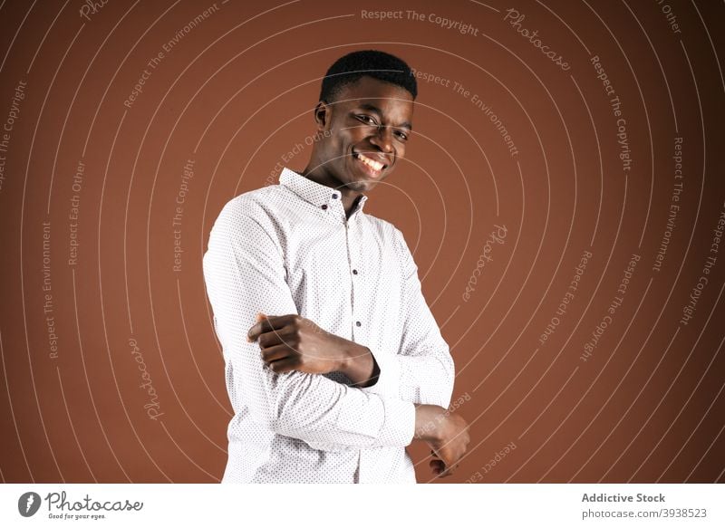Cheerful black man in white shirt in studio classic outfit cheerful handsome smile style confident male ethnic african american positive delight glad optimist