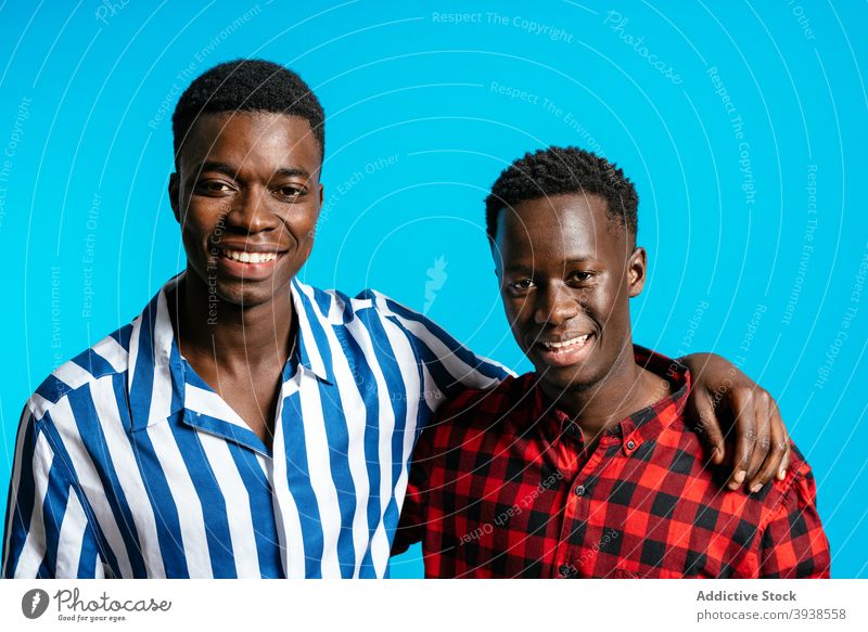 Delighted black men standing together in studio friendship cheerful best friend style outfit carefree male ethnic african american smile happy contemporary