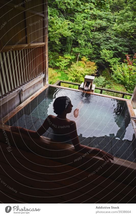 Silhouette of young caucasian woman in Japanese onsen 30s attractive tourist tourism gues