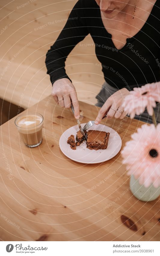 Woman eating dessert in cafe confectionery cake chocolate woman sweet food cafeteria female hand coffee cupcake cut tasty delicious yummy treat palatable cocoa