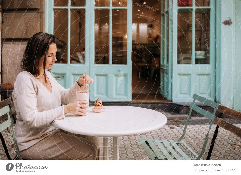 Woman having coffee break with dessert in cafe woman confectionery cupcake candy eat sweet cafeteria terrace food female tasty delicious yummy treat customer