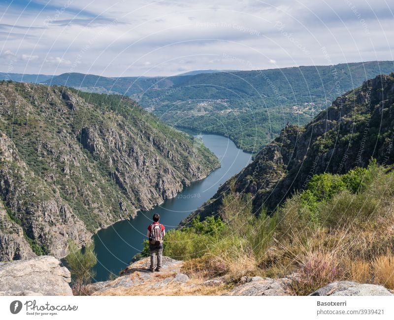 Hiker on a rocky hill overlooking the Rio Sil in the Ribeira Sacra in Galicia, Spain Orense Ourense Río Sil Landscape Water Nature Exterior shot Summer Tourism