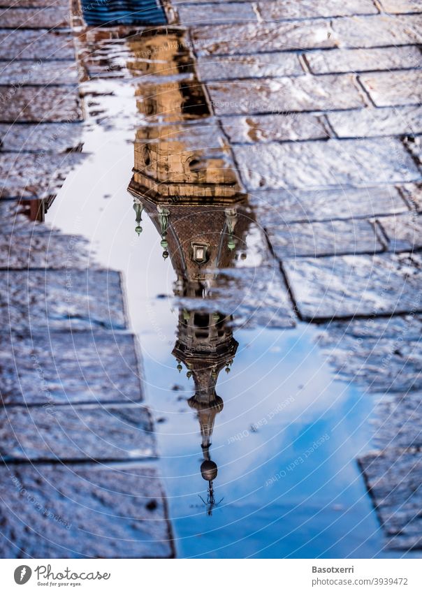 Tower of San Pedro church reflected in a puddle of the old town of Vitoria-Gasteiz, Basque Country, Spain Church Church spire Bell tower Old town Puddle