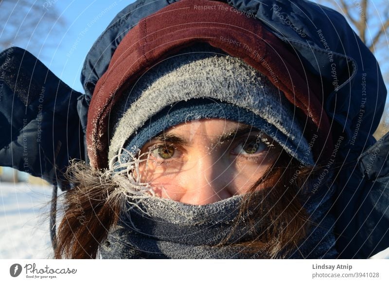 Woman peering out of multiple layers of winter clothing Winter Eyes Frost Cold freezing Snow