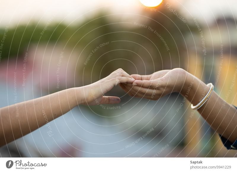 Woman and child holding hands outdoors at sunset bonding togetherness calm mother daughter help assistance giving hope trust love peace finger symbolic family