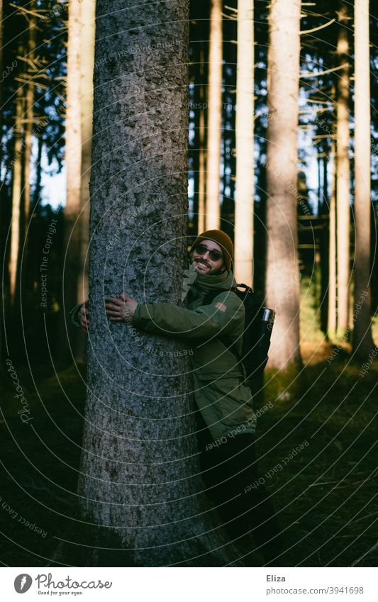 A man hugs a tree in the forest Forest Tree remarry Environmental protection Nature nature lovers close to nature Man Joy guard sb./sth. nature conservation