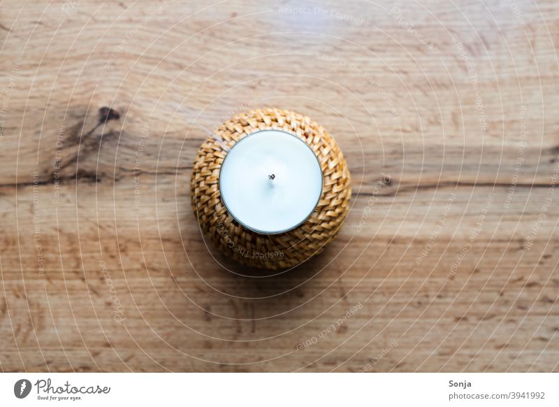 A blown out candle with smoke on a wooden table. shoulder stand Smoke Rustic Interior shot Warmth Candlewick Hot Wax Grief Tea warmer candle Dangerous Cozy