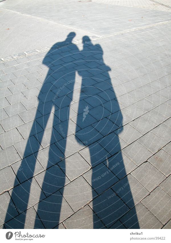 pair of shadows Pedestrian precinct Stone slab Silhouette Man Woman Shadow Cobblestones Couple Graffiti Sun Legs Love In pairs