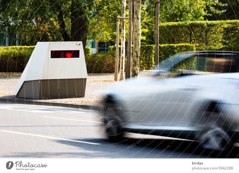 Radar measurement with an enforcement trailer. Motorist being flashed by a modern mobile speed camera. Enforcement trailer, mobile speed camera speed cameras