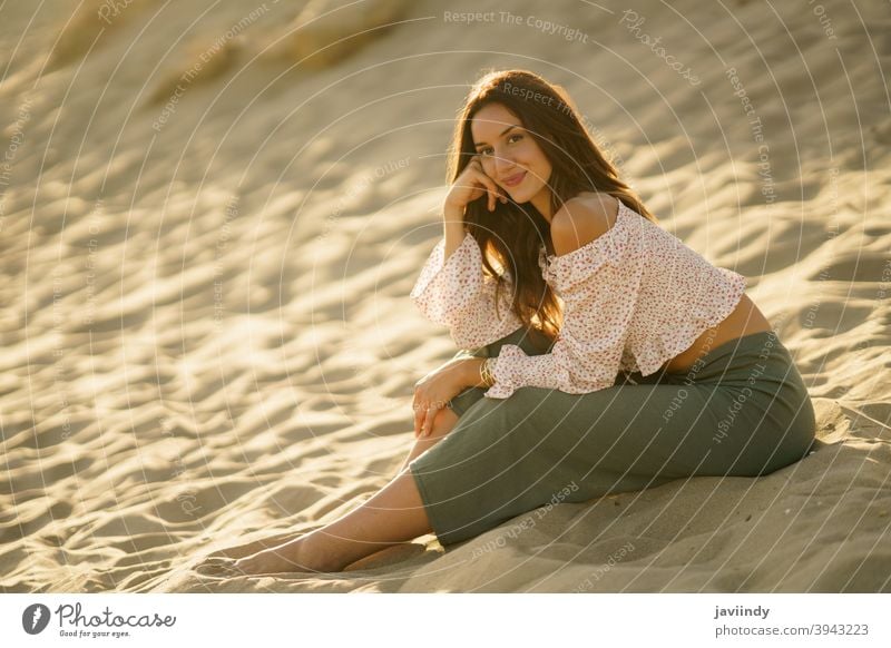Attractive woman sitting on the sand of the beach adult person vacation caucasian female lady girl holiday relax outside young travel summer outdoors people
