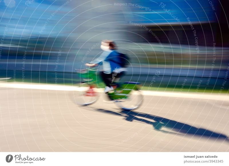cyclist on the street in Bilbao city spain biker bicycle transportation cycling biking exercise ride speed fast blur blurred motion movement defocused road