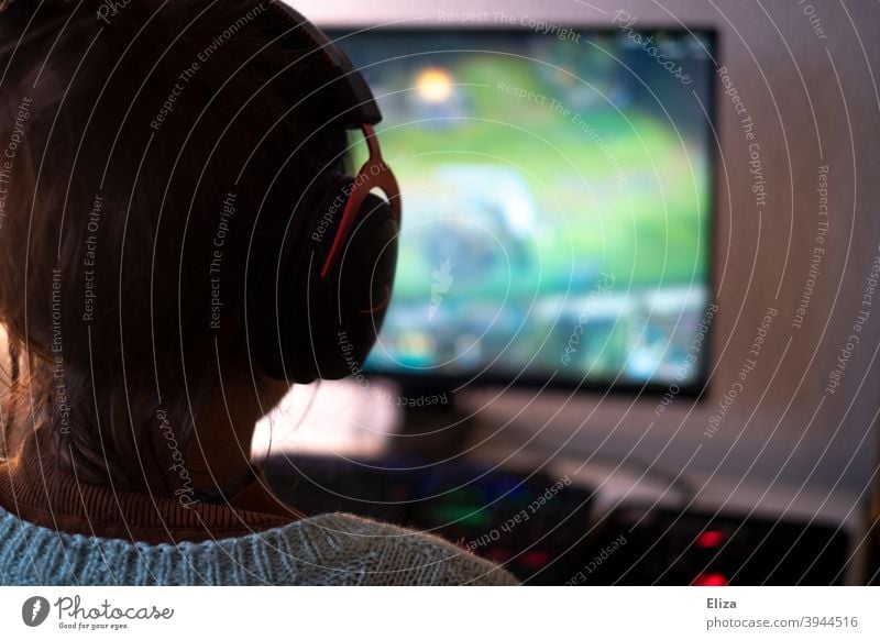 Young woman with headset playing games on PC. Gaming. Headset gaming Woman Playing gambling Technology Leisure and hobbies Computer games Calculator pc PC game