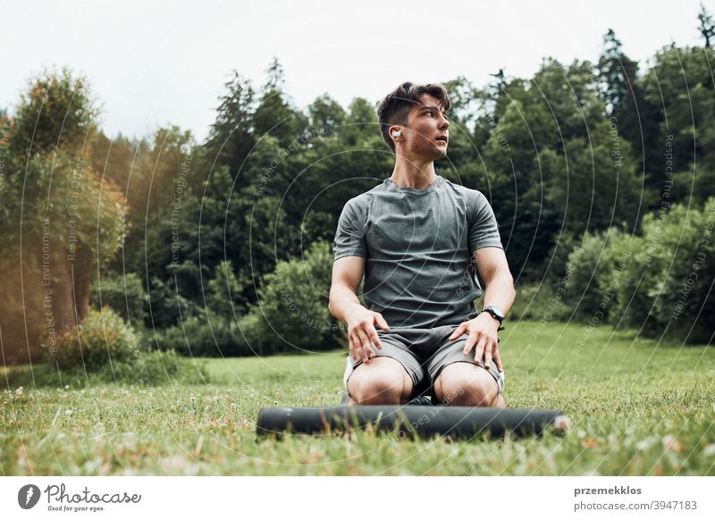 Young man doing exercises outside on grass during his calisthenics workout active activity athlete athletic body bodybuilder bodybuilding care caucasian cross