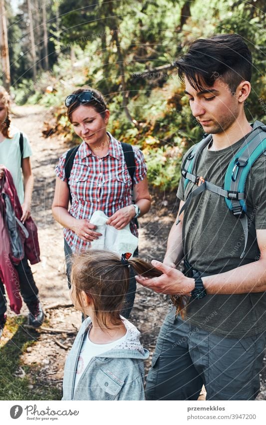 Family with backpacks hiking in a mountains actively spending summer vacation together activity adventure female forest forest landscape forest path freedom fun