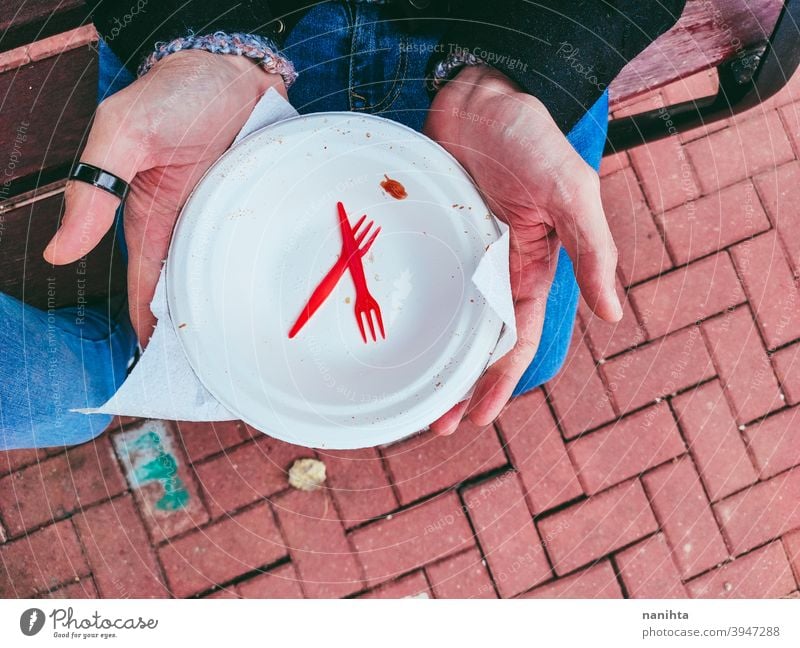 Disposable plate and cutlery disposable dish empty single use trash knife plastic microplastic fork hold holding picnic hands man male young no sustainable