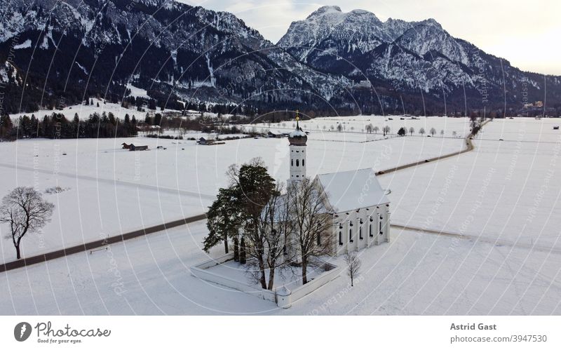 Drone shot of the baroque Colomanskirche near Schwangau in Bavaria in winter droning Aerial photograph Church colomankirche Winter Snow house of God Baroque